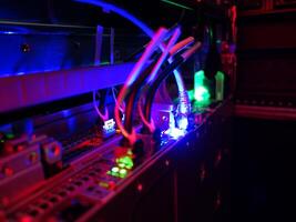 A computer with wires and a red light photo