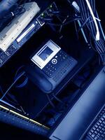 A computer with a phone and a keyboard photo