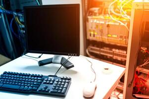 A computer monitor and keyboard sitting on a desk photo