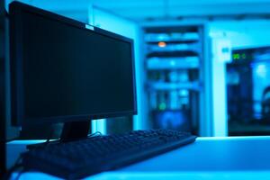 A computer monitor and keyboard sitting on a desk photo