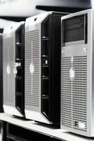 Several dell servers are lined up on a shelf photo