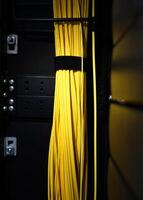 Yellow cables in a rack of a server room photo
