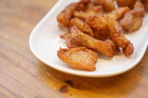 A white plate with fried food on it photo