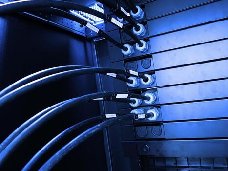 A close up of a rack of servers with cables photo