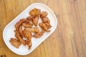 A white plate with fried chicken on it photo