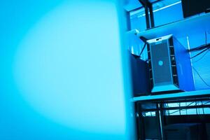 A computer tower in a room with a blue light photo