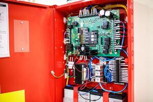 A red cabinet with electrical components inside photo
