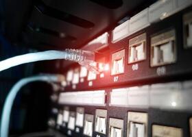 A close up of a network switch with a blue light photo