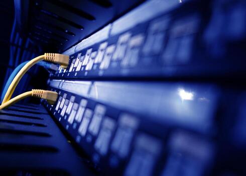 A close up of a network server with yellow cables photo