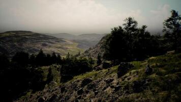Panoramic view of rugged hills and valleys under a cloudy sky in daytime video