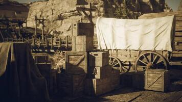 Old wooden crates stacked near a covered wagon in a historic setting video