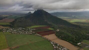 Aerial photography of the beautiful green countryside of Mauritius with fields and mountain views. photo
