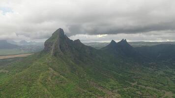 shooting from top to bottom the peaks of mountains and jungles of Mauritius, the sky in clouds photo