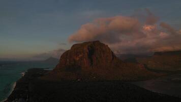 Amazing sunset from the height of mount Le Morne Brabant and the waves of the Indian ocean in Mauritius .Underwater waterfall near mount Le Morne in the Indian ocean. photo