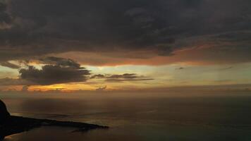 Amazing sunset from the height of mount Le Morne Brabant and the waves of the Indian ocean in Mauritius .Underwater waterfall near mount Le Morne in the Indian ocean. photo