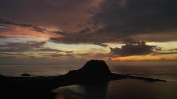 Amazing sunset from the height of mount Le Morne Brabant and the waves of the Indian ocean in Mauritius .Underwater waterfall near mount Le Morne in the Indian ocean. photo
