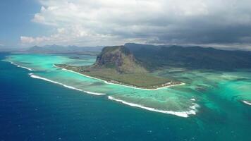 Beautiful bird's-eye view of mount Le Morne Brabant and the waves of the Indian ocean in Mauritius.Underwater waterfall near mount Le Morne in the Indian ocean photo