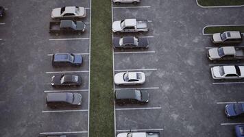 Aerial view of empty parking lot with cars positioned in neat rows video