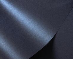 Luxurious designer paper background in deep navy blue with a glossy, satin finish and rich gradient. photo