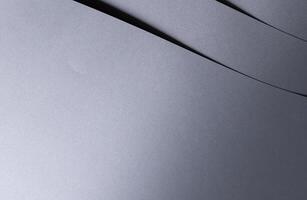 Elegant designer paper background with a smooth, glossy metallic gradient in rich gray tones. This photo
