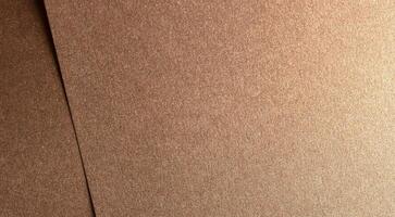 Glossy bronze designer paper with a shining, metallic gradient and textured finish. Elegant and photo