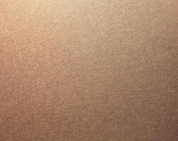 Glossy designer paper background with a rich bronze and copper gradient, featuring a warm, grainy photo