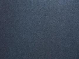 Luxurious designer paper background in deep navy blue with a smooth, satin like texture and subtle photo