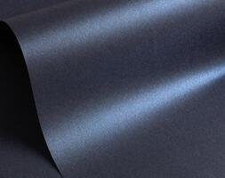 Glossy designer paper background with a deep navy blue gradient and a cool, metallic satin finish. photo