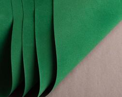 Paper texture background. Premium designer sheet with deep emerald shade and curved, wavy layers. photo