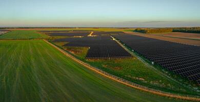 Aerial View of Expansive Solar Panel Field in Lithuania photo