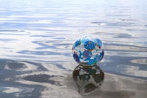 Beach ball on the water surface with place for text. photo
