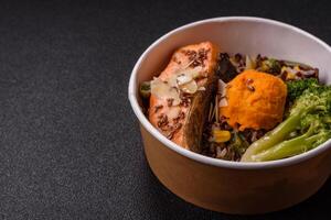 Grilled salmon with salt and spices, broccoli, tomatoes, rice photo