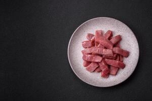 Juicy beef cut into slices with salt, spices and herbs photo