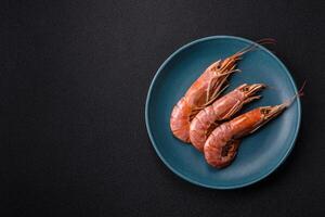 Boiled tiger prawns with salt, spices, herbs and vegetables photo