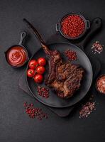Grilled wagyu beef tomahawk steak with salt, spices and herbs photo
