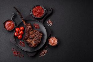 Grilled wagyu beef tomahawk steak with salt, spices and herbs photo