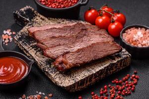 Grilled wagyu beef tomahawk steak with salt, spices and herbs photo