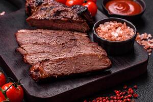 Grilled wagyu beef tomahawk steak with salt, spices and herbs photo