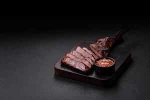 Grilled wagyu beef tomahawk steak with salt, spices and herbs photo