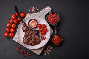 Grilled wagyu beef tomahawk steak with salt, spices and herbs photo