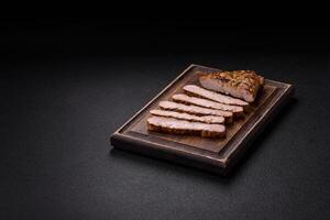 Grilled beef or pork steak with salt, spices and herbs photo
