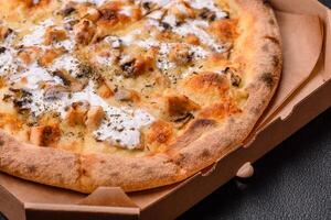 Creamy pizza with truffle cheese, mozzarella, chicken and mushrooms photo