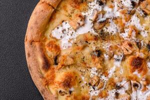 Creamy pizza with truffle cheese, mozzarella, chicken and mushrooms photo