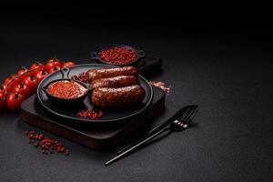 Juicy sausages with salt, spices and herbs photo