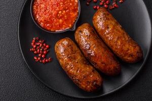Juicy sausages with salt, spices and herbs photo