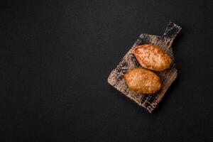 Delicious fresh fried minced fish cutlets with spices and herbs photo
