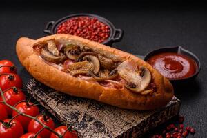 Hotdog with grilled sausage with bacon and mushrooms photo