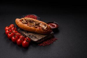 Hotdog with grilled sausage with bacon and mushrooms photo