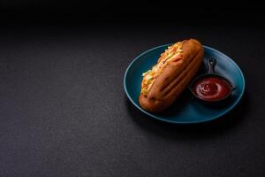 Hotdog with grilled sausage with cabbage, carrots and onions photo