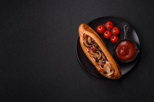 Hotdog with grilled sausage with bacon and mushrooms photo